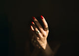 shining ring on hand in black background