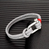 Grey rope bracelet featuring a stainless steel U-clasp, perfect for casual and formal wear.