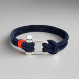 Navy blue rope bracelet featuring a durable silver U-clasp and red accents.