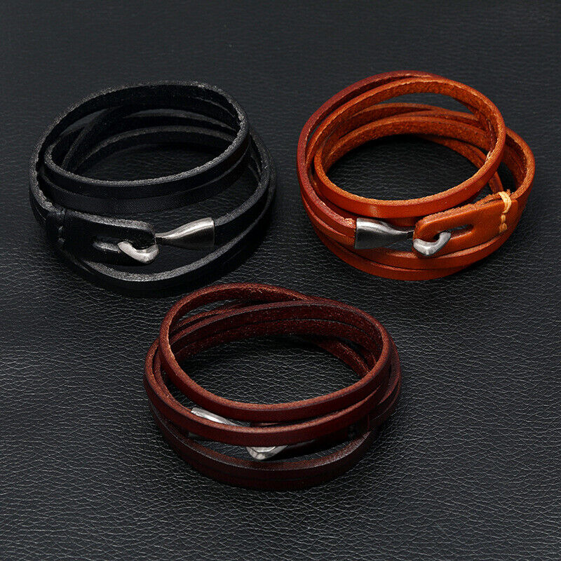 leather bracelets on black surface