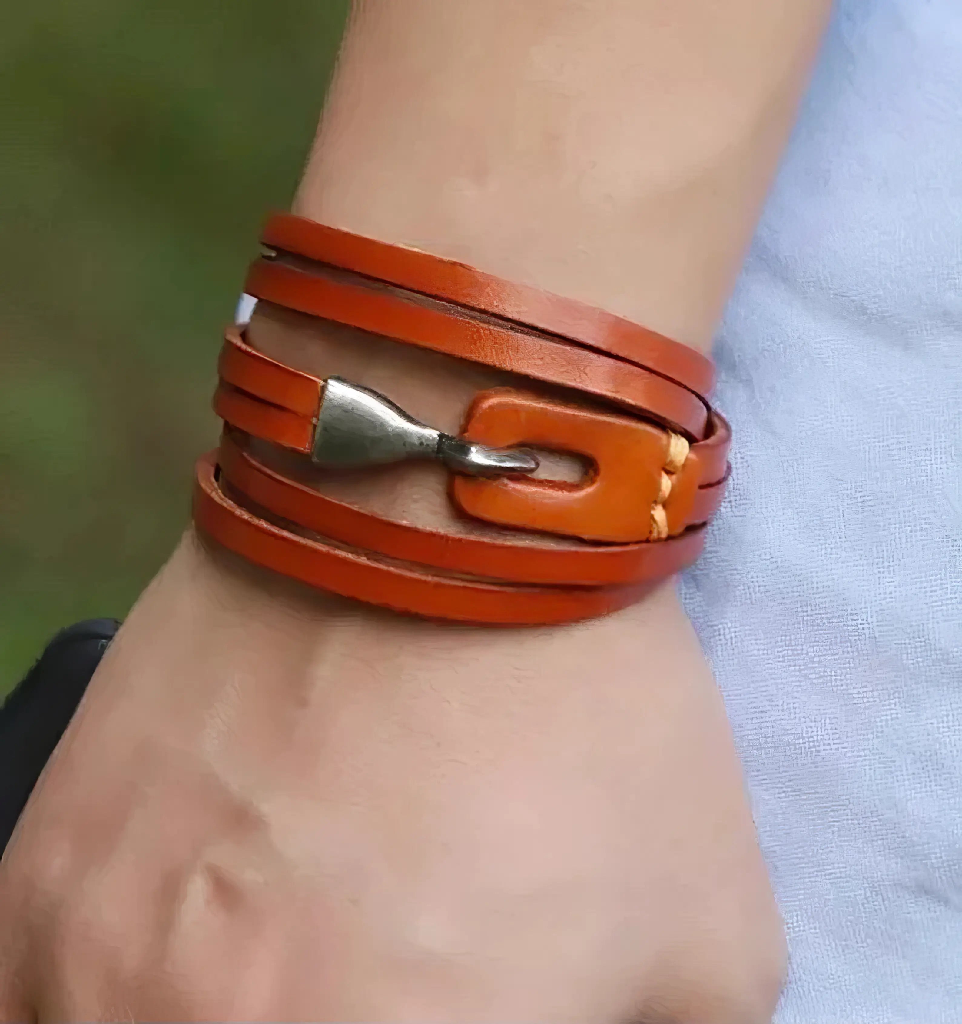 orange leather bracelet for men on hand