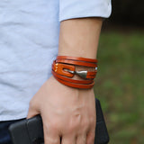 orange leather bracelet on hand